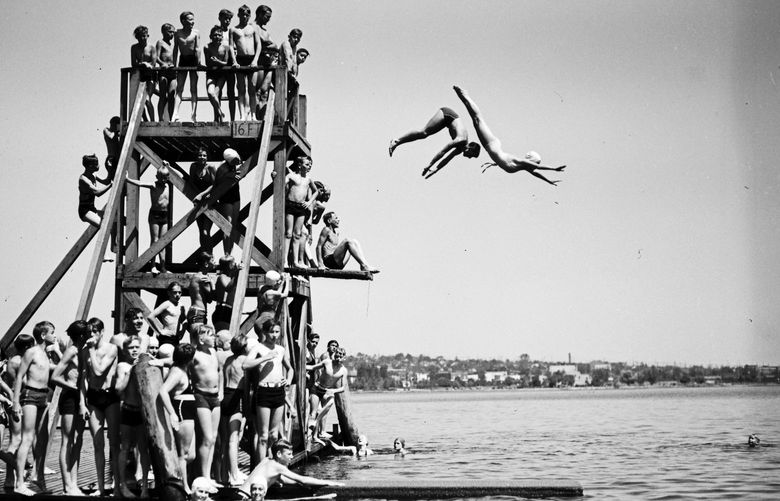 No way such a diving board would exist today. But it did when this photo was taken June 25, 1936 at Green Lake. At 16 feet, its high platform is 4 feet than what is allowed in Seattleâ€™s parks. And all those kids crowded at the top? No, no. Only one diver at a time, please. Credit: Seattle Municipal Archives.
