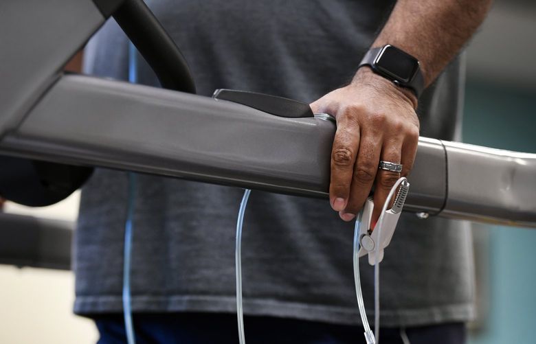 Patient Gary Cardona wears a pulse oximeter to keep track of his oxygen intake as he works out on the treadmill during his physical therapy at National Jewish Health on March 3, 2021, in Denver. Cardona suffers from lingering symptoms of COVID-19, with the most bothersome being what he describes as brain fog and short term memory problems. (Helen H. Richardson/The Denver Post/TNS) 49919482W 49919482W