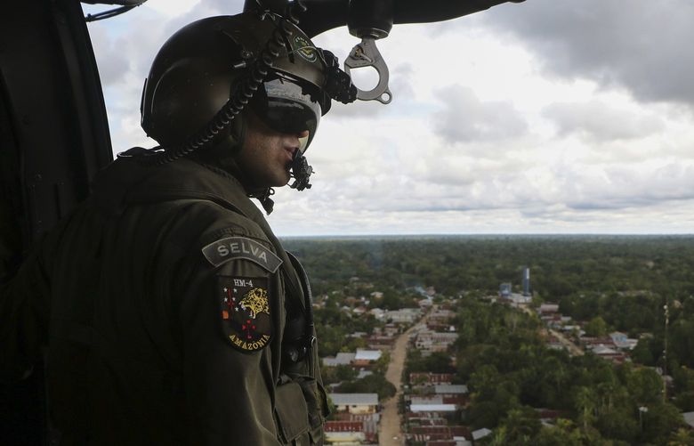 Soldiers search for missing British journalist Dom Phillips and Indigenous affairs expert Bruno Araujo Pereira from a helicopter over Javari Valley Indigenous territory, Atalaia do Norte, Amazonas state, Brazil, Friday, June 10, 2022. Phillips and Pereira were last seen on Sunday morning in the Javari Valley, Brazil’s second-largest Indigenous territory which sits in an isolated area bordering Peru and Colombia. (AP Photo/Edmar Barros) XAP105 XAP105