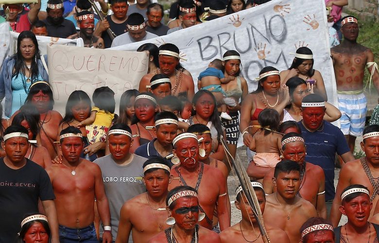 Indigenous people march to protest against the disappearance of Indigenous expert Bruno Pereira and freelance British journalist Dom Phillips, in Atalaia do Norte, Vale do Javari, Amazonas state, Brazil, Monday, June 13, 2022. Brazilian police are still searching for Pereira and Phillips, who went missing in a remote area of Brazil’s Amazon a week ago. (AP Photo/Edmar Barros) XEP112 XEP112