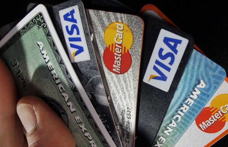 FILE – In this March 5, 2012, file photo, consumer credit cards are posed in North Andover, Mass.  (AP Photo/Elise Amendola, File) 
