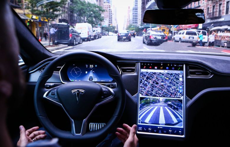 A driver rides hands-free in a Tesla Motors Inc. Model S vehicle equipped with Autopilot hardware and software in New York, U.S. on Monday, Sept. 19, 2016. The latest overhaul of the car’s operating system, known as Tesla 8.0, biggest change is how Autopilot shifts towards a heavier reliance on its radar than its camera to guide the car through traffic. Photographer: Christopher Goodney/Bloomberg