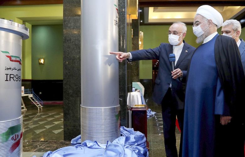 FILE – In this April 10, 2021, file photo released by the official website of the office of the Iranian presidency, Iranian President Hassan Rouhani, second from right, listens to the head of the Atomic Energy Organization of Iran Ali Akbar Salehi while visiting an exhibition of Iran’s new nuclear achievements in Tehran, Iran. Iran’s nuclear program has been targeted by diplomatic efforts and sabotage attacks over the last decade, with the latest incident striking its underground Natanz facility. The attack Sunday, April 11, 2021 at Natanz comes as world powers try to negotiate a return by Iran and the U.S. to Tehran’s atomic accord. (Iranian Presidency Office via AP, File) IRN101