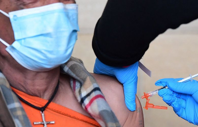 A man receives his COVID-19 vaccine at Union Station in Los Angeles on Jan. 7, 2022. (Frederic J. Brown/AFP via Getty Images/TNS) 50651250W 50651250W