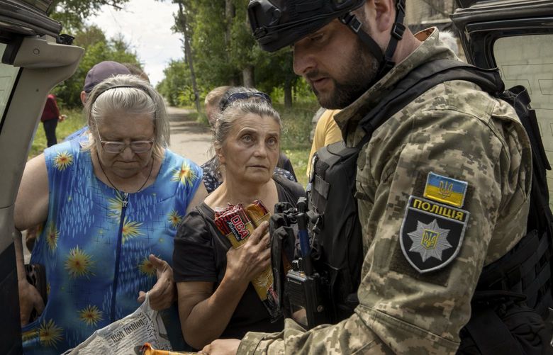 Ukrainian soldiers and police deliver food supplies to residents in Lysychansk, Ukraine, June 16, 2022.  (Tyler Hicks/The New York Times) XNYT5 XNYT5