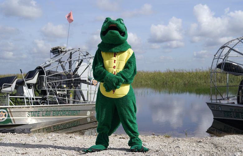 Freddy the Friendly Alligator, the mascot for the South Florida Water Management District, stands at a media event where Florida Gov. Ron DeSantis announced that registration for the 2022 Florida Python Challenge has opened for the annual 10-day event to be held Aug 5-14, Thursday, June 16, 2022, in Miami. The Python Challenge is intended to engage the public in participating in Everglades conservation through invasive species removal of the Burmese python. (AP Photo/Lynne Sladky) OTK OTK