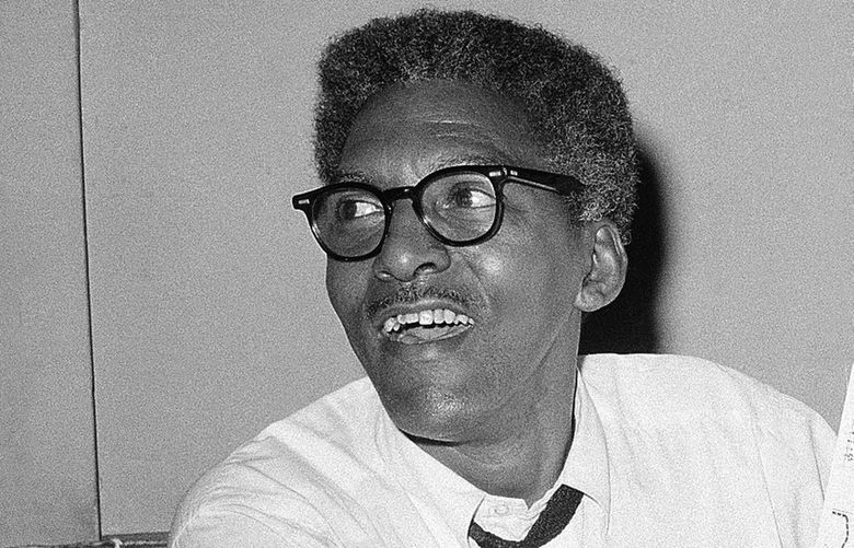 FILE – Bayard Rustin, deputy director of the planned march on Washington program, points to a map showing the line of march for the demonstration for civil rights during a news conference in New York on Aug. 24, 1963.   (AP Photo, File) NY108 NY108