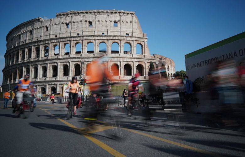FILE – In this Friday, June 5, 2020 file photo, people cycle during a demonstration in front of the ancient Colosseum in Rome. The European Union on Wednesday, May 19, 2021 took a step toward relaxing tourism travel for visitors from outside the bloc, with EU ambassadors agreeing on measures to allow fully vaccinated visitors in. They also agreed on easing the criteria for nations to be considered a safe country, from which all tourists can travel. Up to now, that list included only seven nations. (AP Photo/Andrew Medichini, File)