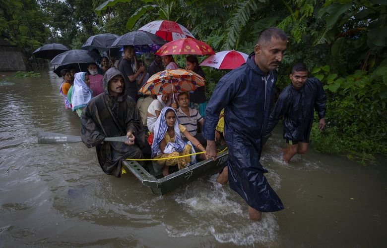 Indian army personnel rescue flood-affected villagers on a boat in Jalimura village, west of Gauhati, India, Saturday, June 18, 2022. (AP Photo/Anupam Nath) AXN109 AXN109