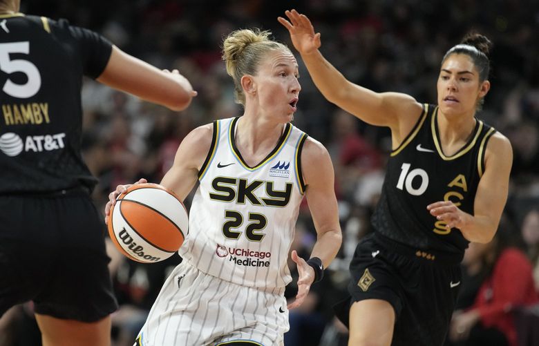 Chicago Sky guard Courtney Vandersloot (22) drives around Las Vegas Aces guard Kelsey Plum (10) during the first half of a WNBA basketball game Tuesday, June 21, 2022, in Las Vegas. (AP Photo/John Locher) NVJL101 NVJL101
