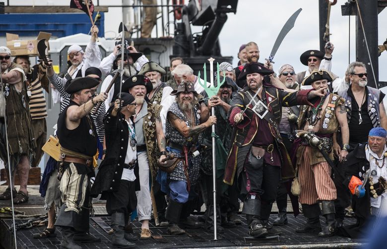 The 2019 Seafair Pirates get ready to storm the beaches of Alki Beach for the Seafair Pirate’s Landing on Saturday, July 6. The pirates greeted scores of people waiting on the beach, followed by a pirate party complete with music and vendors.  210785