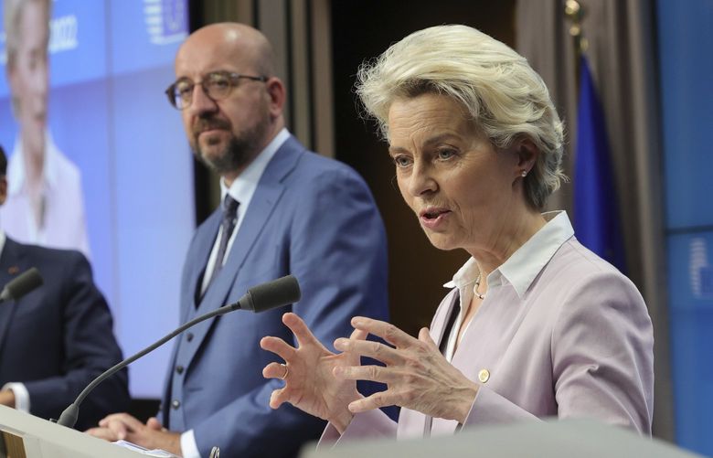 From right, European Commission President Ursula von der Leyen, European Council President Charles Michel and French President Emmanuel Macron address a media conference at an EU summit in Brussels, Thursday. The European Union’s leaders have agreed to make Ukraine a candidate for EU membership, setting in motion a potentially years long process that could draw the embattled country further away from Russia’s influence and bind it more closely to the West. (Olivier Matthys / The Associated Press)