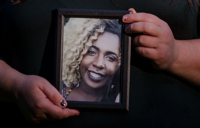 Jennifer Titterness holds a framed photo of her friend Li’ahnna Mathis outside her home in Port Orchard, WA on June 21, 2022. Mathis died by suicide at the King County Jail in December, a month before the jail started to see an alarming string of suicides in custody.