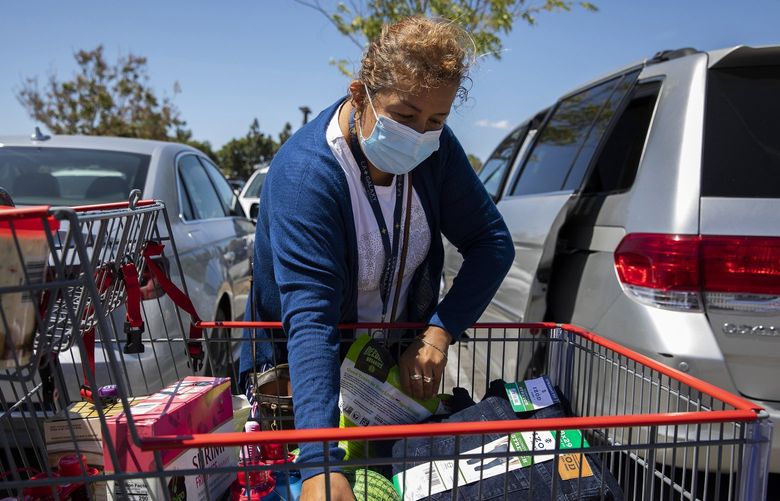 FILE â€” A shopper loads groceries into her car after shopping at Costco in Marina Del Ray, Calif., May 10, 2022. Americans are confronting more expensive food, fuel and housing, and some are grasping for answers about what is causing the price burst, how long it might last and what can be done to resolve it. (Alisha Jucevic/The New York Times) XNYT74 XNYT74