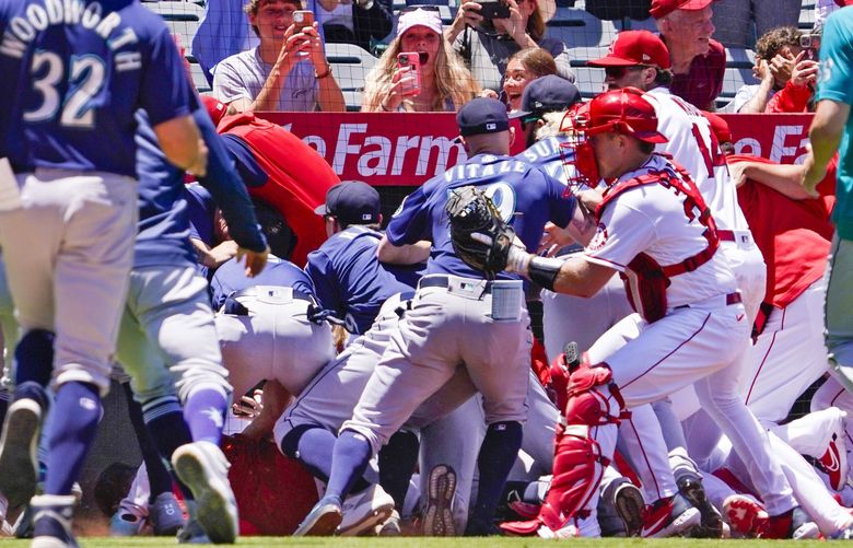 Several members of the Seattle Mariners and the Los Angeles Angels scuffle after Mariners’ Jesse Winker was hit by a pitch during the second inning of a baseball game Sunday, June 26, 2022, in Anaheim, Calif. (AP Photo/Mark J. Terrill) ANS106
