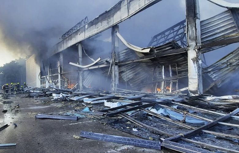 In this image made from video provided by Ukrainian State Emergency Service, firefighters work to extinguish a fire at a shopping center burned after a rocket attack in Kremenchuk, Ukraine, Monday, June 27, 2022. (Ukrainian State Emergency Service via AP) UKR104 UKR104