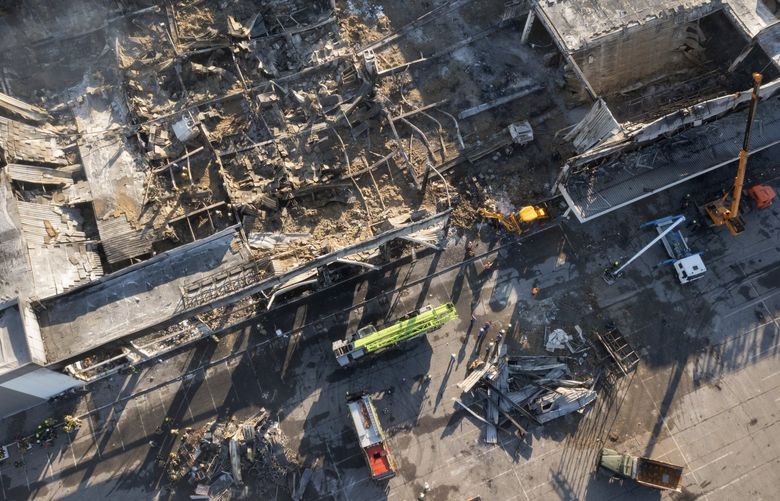 Ukrainian State Emergency Service firefighters work to take away debris at a shopping mall burned after a missile strike in Kremenchuk, Ukraine, Tuesday, June 28, 2022. (AP Photo/Efrem Lukatsky) XEL106 XEL106