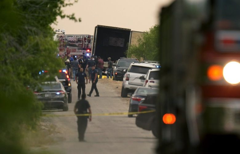 Body bags lie at the scene where a tractor trailer with multiple dead bodies was discovered, Monday, June 27, 2022, in San Antonio. (AP Photo/Eric Gay) TXEG107 TXEG107