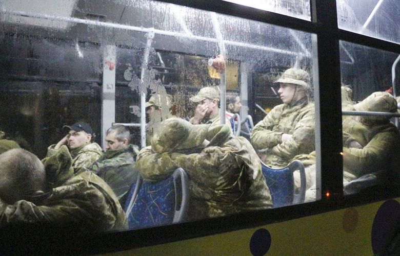 Ukrainian servicemen sit in a bus after leaving Mariupol’s besieged Azovstal steel plant, near a penal colony, in Olyonivka, in territory under the government of the Donetsk People’s Republic, eastern Ukraine, Friday, May 20, 2022. (AP Photo) MAR103