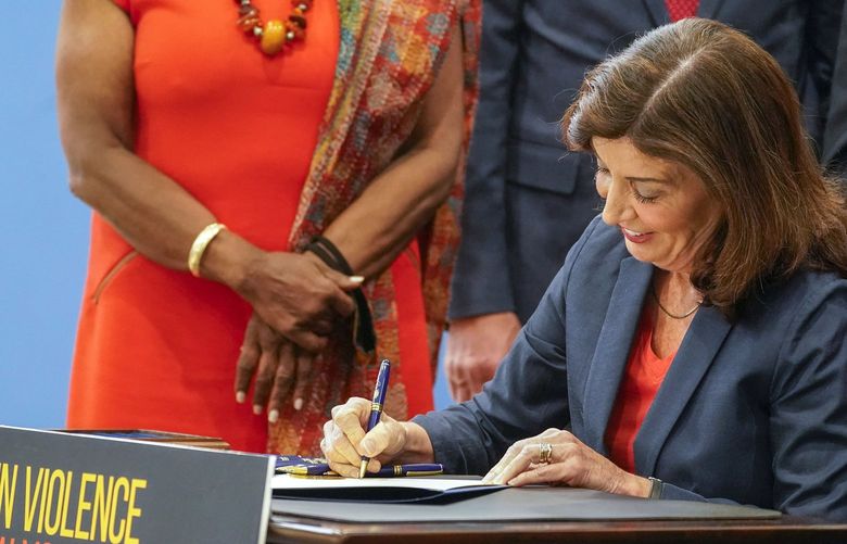 FILE â€” New York Gov. Kathy Hochul signs a package of bills to strengthen gun laws, June 6, 2022, in New York. The Supreme Court, Thursday, June 23, 2022, struck down a restrictive New York gun law in a major ruling for gun rights. (AP Photo/Mary Altaffer, File) NYRD408 NYRD408