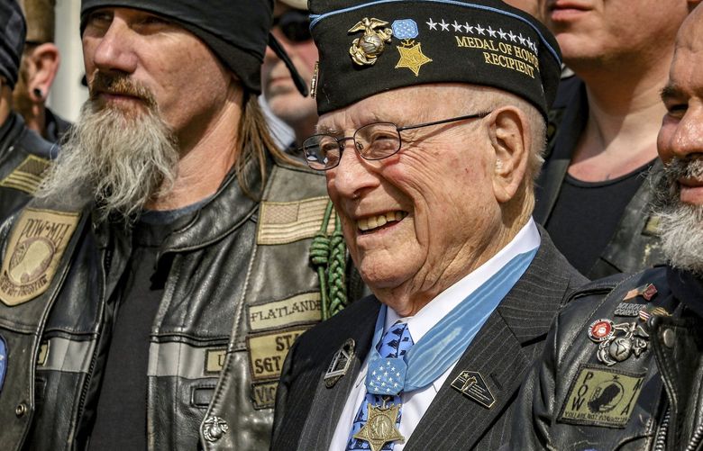 FILE – Hershel “Woody” Williams, center, the sole surviving U.S. Marine to be awarded the Medal of Honor during World War II, poses with fellow Marines at the Charles E. Shelton Freedom Memorial at Smothers Park, Saturday, April 6, 2019, in Owensboro, Ky. Williams, the last remaining Medal of Honor recipient from World War II, died Wednesday, June 29, 2022 He was 98. Williams’ foundation announced on Twitter and Facebook that he died at the Veterans Affairs medical center bearing his name in Huntington. (Greg Eans/The Messenger-Inquirer via AP, File ) KYOWE757 KYOWE757