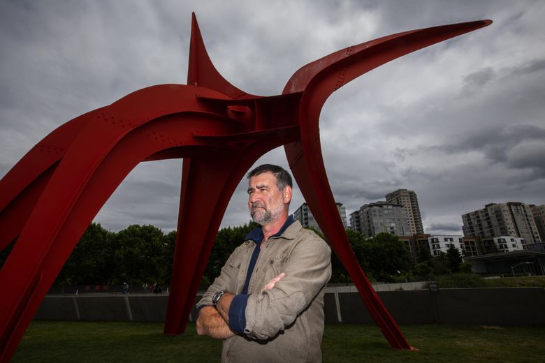 Bobby McCullough, manager of facilities and  landscape at Seattle Art Museum’s Olympic Sculpture Park, says, “I’m over it,” when it comes to all the bunnies running around in the park. In the background is “Eagle” by Alexander Calder, which is one raptor these rabbits don’t fear. (Ken Lambert / The Seattle Times)