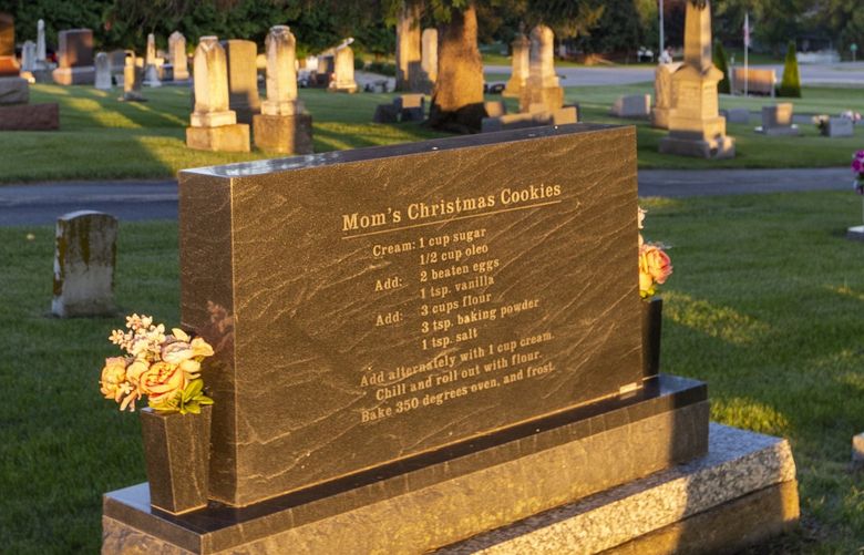 A German Christmas cookie recipe on the grave of Maxine Kathleen Poppe Menster, in Cascade, Iowa on June 8, 2022. They say you can’t take it with you, but recipes often disappear when loved ones die. Some families are finding a novel way to record them for posterity. (Rachel Mummey/The New York Times) XNYT226 XNYT226