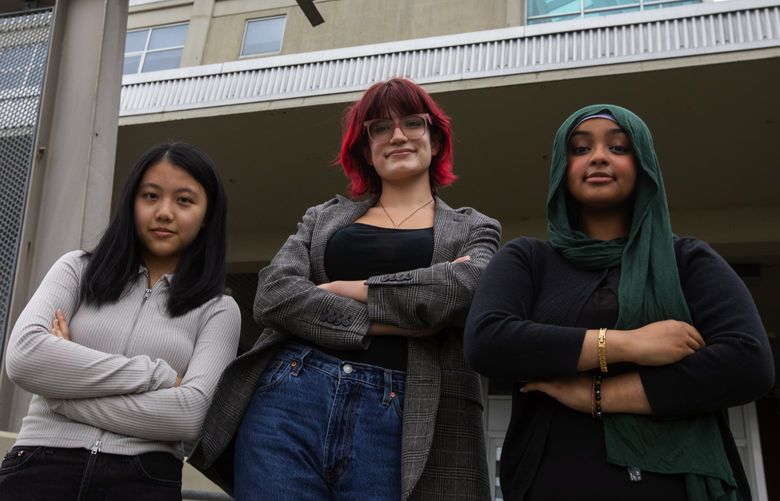 Three Seattle Public School students who have been chosen to be student board members, from left: Jia Li “Jenna” Yuan, Luna Crone-Baron and Nassira Hassan, Wednesday, June 22, 2022 outside SPL headquarters before each addressed the school board.