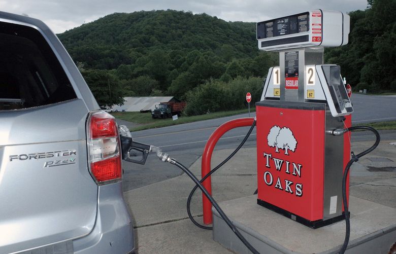 FILE – A car at a gas station pump in Sparta, N.C., on May 14, 2022. Soaring energy prices have added to inflation, draining people’s wallets and cutting into corporate profits. (John Taggart/The New York Times)
