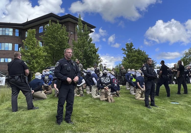 Authorities arrest members of the white supremacist group Patriot Front near a pride event Saturday in Coeur d’Alene, Idaho.  (Georji Brown / The Associated Press)
