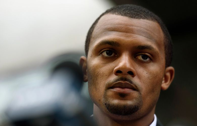 FILE — The football star Deshaun Watson speaks to reporters after a grand jury declined to indict the Texans quarterback on criminal charges in Houston on March 11, 2022. The accusations have been frequent and startling: more than two dozen women have said Watson harassed or assaulted them during massage appointments that Watson and his lawyers insist were innocuous. (Callaghan O’Hare/The New York Times)