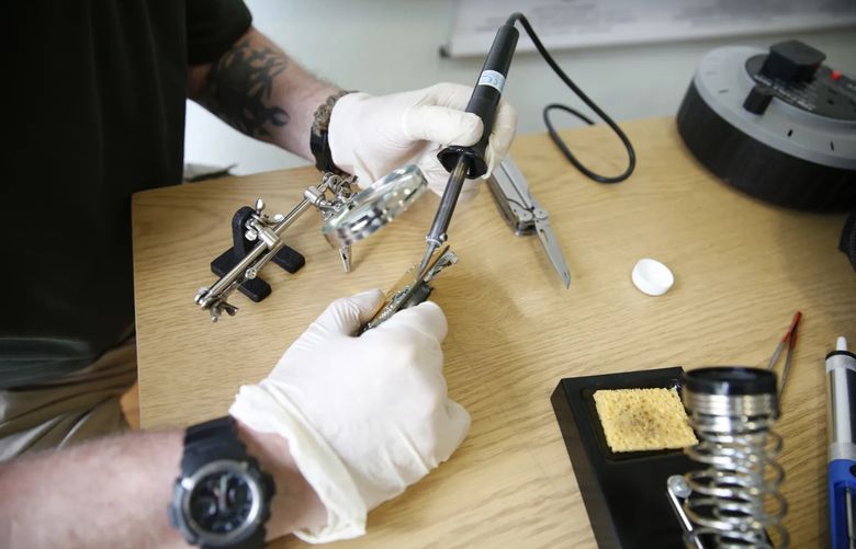 A photo provided by Conflict Armament Research of an investigator desoldering a component from a Russian surveillance drone collected by security officials working in Ukraine in May of 2022. The tools that Russian forces are using to wage war in Ukraine are often powered by American innovation. (Conflict Armament Research via The New York Times)