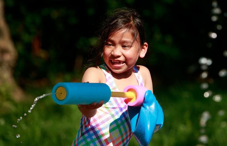 Fyroi Caballero CQ, 7, cools off in the water at the Georgetown Playfield spray park in Seattle Monday, June 27, 2022.  Temperatures reached into the 90s in the Seattle-area Monday afternoon. 
 220816