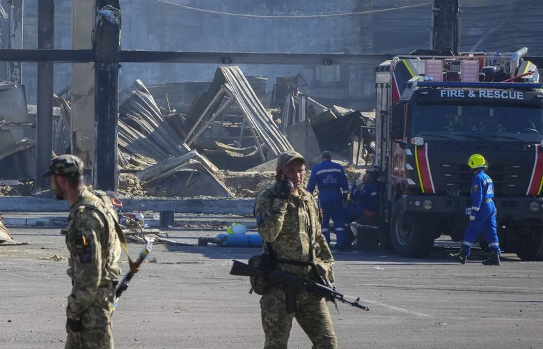 Ukrainian soldiers stand in front of a shopping center burned after a rocket attack in Kremenchuk, Ukraine, Tuesday, June 28, 2022. (AP Photo/Efrem Lukatsky) XEL112 XEL112