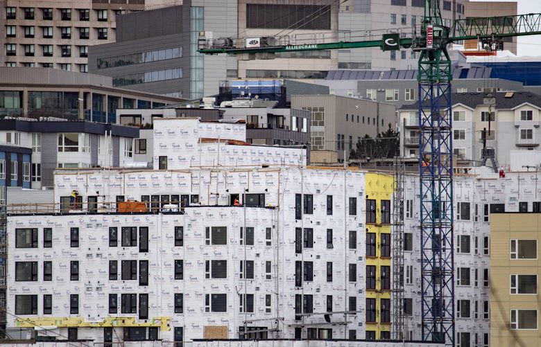 A massive apartment project goes up with First Hill in the background, as high-density housing construction continues in Seattle, Tuesday, Feb. 1, 2022. The view is from Beacon Hill. 219487