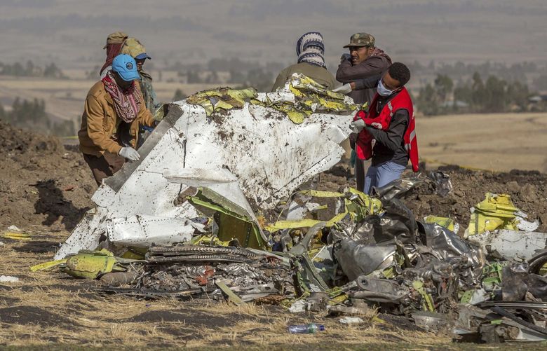 Rescuers work at the scene of an Ethiopian Airlines flight crash near Bishoftu, or Debre Zeit, south of Addis Ababa,  Ethiopia, Monday, March 11, 2019.  (AP Photo/Mulugeta Ayene)