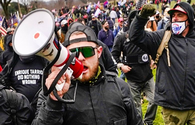 Ethan Nordean, with megaphone, leads a group who claim they are members of the Proud Boys in support of President Donald Trump in Washington, D.C. Wednesday, Jan. 6, 2021.  (AP Photo/Carolyn Kaster)