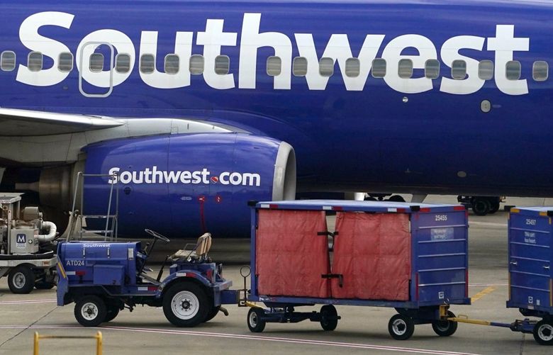 Southwest planes and baggage carts at Hartsfield-Jackson Atlanta International Airport in Atlanta, on Dec. 27. MUST CREDIT: Bloomberg photo by Elijah Nouvelage.