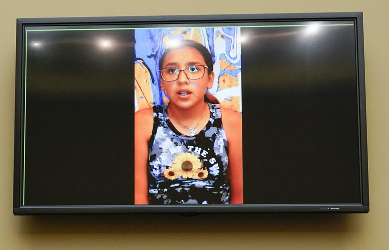 Miah Cerrillo, a fourth grade student at Robb Elementary School in Uvalde, Texas, and survivor of the mass shooting appears on a screen during a House Committee on Oversight and Reform hearing on gun violence on Capitol Hill in Washington, Wednesday, June 8, 2022. (AP Photo/Andrew Harnik, Pool) DCAH433 DCAH433
