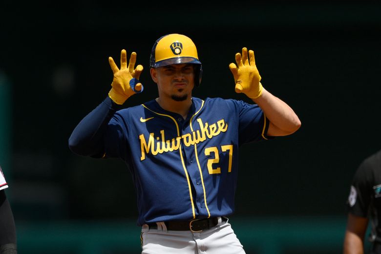 Milwaukee Brewers' Willy Adames, right, celebrates after his base