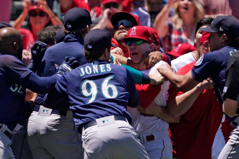 Several members of the Seattle Mariners and the Los Angeles Angels scuffle after Mariners’ Jesse Winker was hit by a pitch during the second inning of a baseball game Sunday, June 26, 2022, in Anaheim, Calif. (AP Photo/Mark J. Terrill)