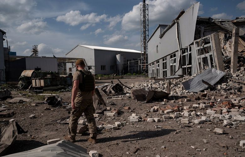 FILE – A Ukrainian soldier walks through the debris from an airstrike in Slovyansk, in the Donbas region on May 13, 2022. Truck-mounted HIMARS multiple-rocket launchers, the most advanced weapons that the United States has so far supplied Ukraine, are making an impact in their first several days on the battlefield, American and Ukrainian officials say. (Lynsey Addario/The New York Times) – NO SALES – XNYT122 XNYT122