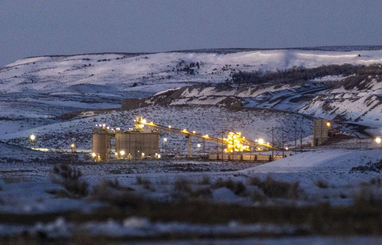 FILE – Lights illuminate a coal mine at twilight, Jan. 13, 2022, in Kemmerer, Wyo. With the nearby coal-fired Naughton Powerplant being decommissioned in 2025, the fate of the coal mine and its workers is uncertain. More than 500 days into his presidency, Joe Biden’s hope for saving the Earth from the most devastating effects of climate change may not be dead. But it’s not far from it after a Supreme Court ruling not only limited the Environmental Protection Agency’s ability to regulate pollution by power plants, but also suggests the court is poised to block other efforts to limit the climate-wrecking fumes emitted by oil, gas and coal. (AP Photo/Natalie Behring, File) wx207 wx207