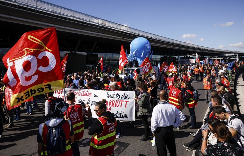 Unionists strikers demonstrate outside a terminal Friday, July 1, 2022 at Roissy airport, north of Paris. Flights from Roissy-Charles de Gaulle airport in Paris and other French airports faced disruptions Friday as airport workers held a strike and protests to demand salary hikes to keep up with inflation. It’s the latest trouble to hit global airports this summer, as travel resurges after two years of virus restrictions. (AP Photo/ Thomas Padilla) PAR109 PAR109