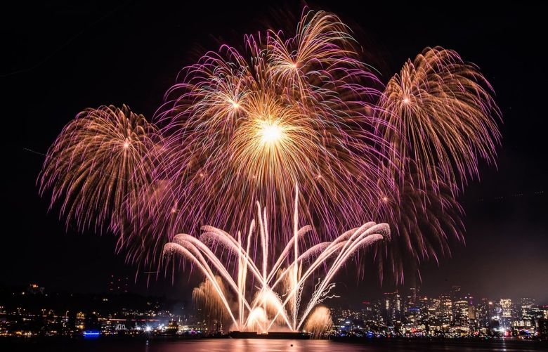 Fireworks erupt over Lake Union in Seattle, Wash., on Monday, July 4, 2022. (Amanda Ray / The Seattle Times)