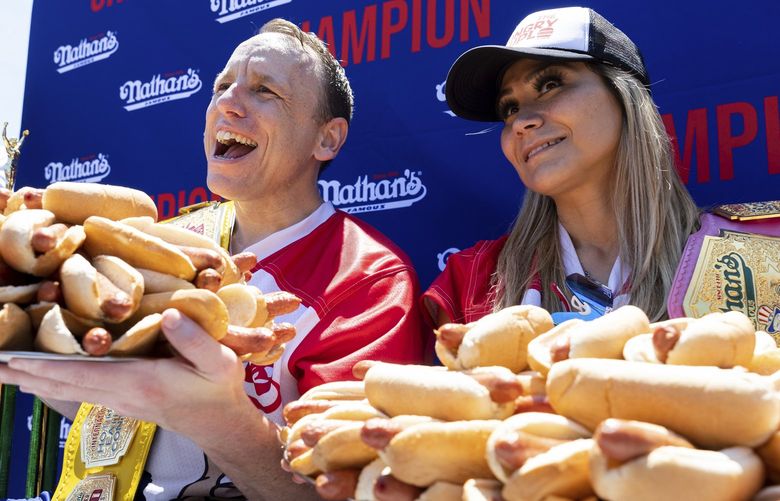 Joey Chestnut and Miki Sudo pose with 63 and 40 hot dogs, respectively, after winning the Nathan’s Famous Fourth of July hot dog eating contest in Coney Island on Monday, July 4, 2022, in New York. (AP Photo/Julia Nikhinson) NYJN107 NYJN107