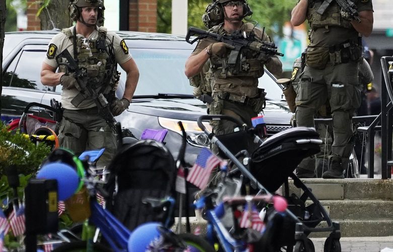 Law enforcement search after a mass shooting at the Highland Park Fourth of July parade in downtown Highland Park, a Chicago suburb on Monday, July 4, 2022. (AP Photo/Nam Y. Huh) OTKNH121 OTKNH121