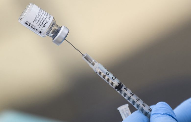 A syringe is filled with a first dose of the Pfizer COVID-19 vaccine at a mobile vaccination clinic during a back to school event at the Weingart East Los Angeles YMCA in Los Angeles, California on Aug. 7, 2021. (Patrick T. Fallon/AFP via Getty Images/TNS) 52333100W 52333100W