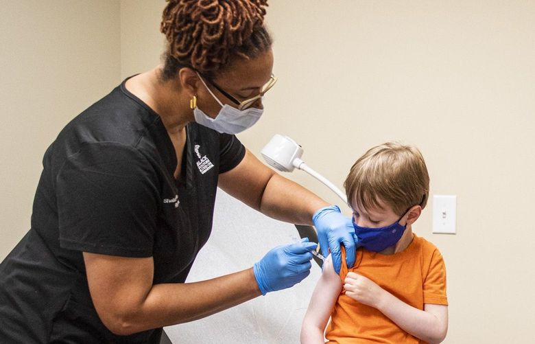 Shelah McMillan, nursing supervisor, gives Oliver Johnson, 3, his COVID-19 vaccine shot with his family at Dr. Ala Stanford Center for Health Equity in Philadelphia on June 23, 2022. (Tyger Williams/The Philadelphia Inquirer/TNS) 52343794W 52343794W