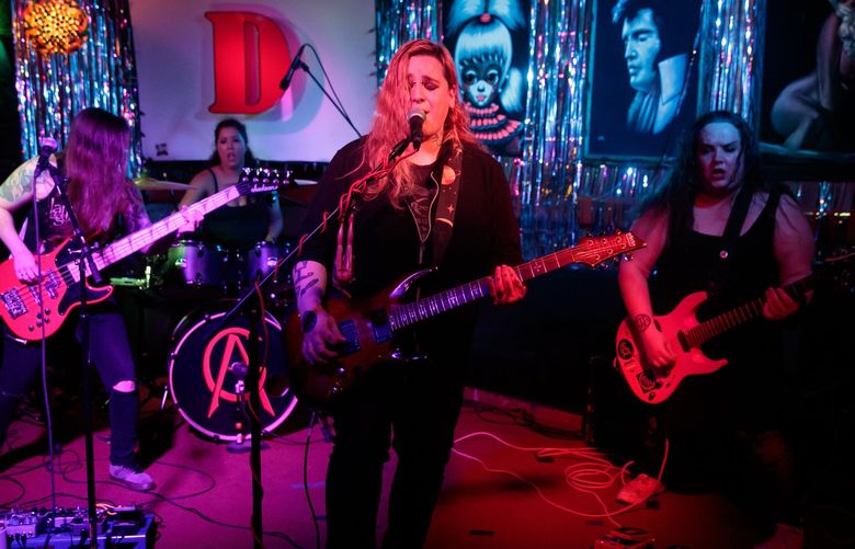 Atrocity Girl bassist Nicole Valles, from left, drummer Angela Dane, vocalist and guitarist Johnny Angel and lead guitarist Ryan Lee perform at Darrell’s Tavern in Shoreline, Wash.Thursday, May 26, 2022. 220408